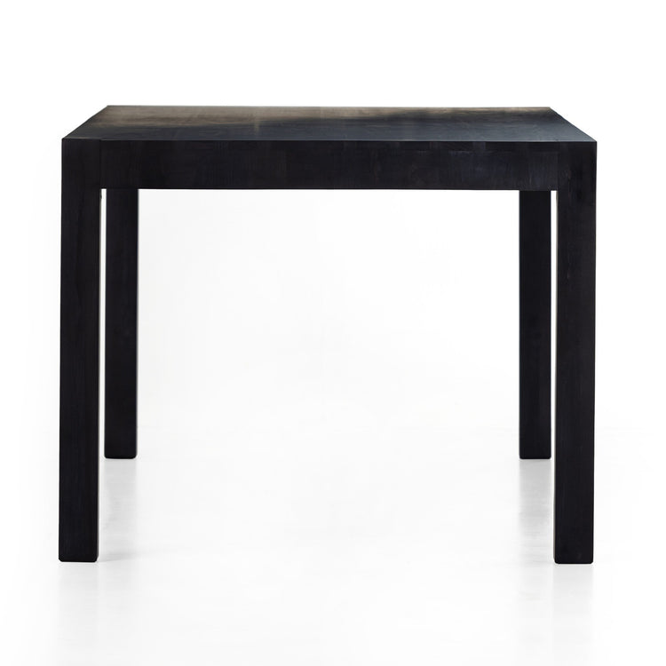 Mesa de comedor de 78” de álamo macizo negro Barsa de lado.